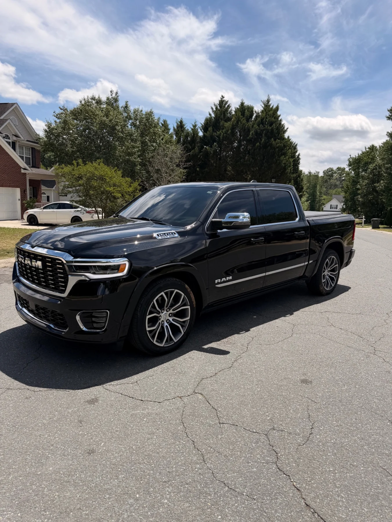 Black RAM 1500 Tungsten with premium tint parked in a residential neighborhood